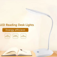 LED reading desk light on a wooden surface with a book and pen, featuring energy efficiency text and icons.