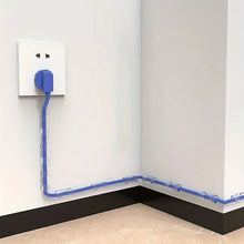 Blue cable running from a wall socket along a corner of a room.